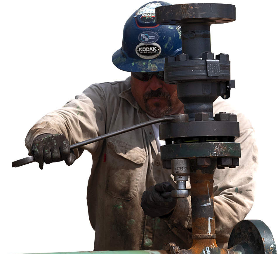 Oilfield worker tightening bolts on rig